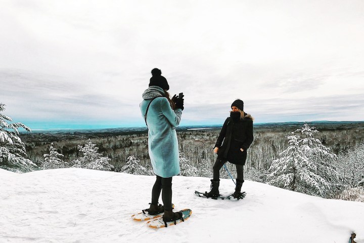 a couple of people that are standing in the snow