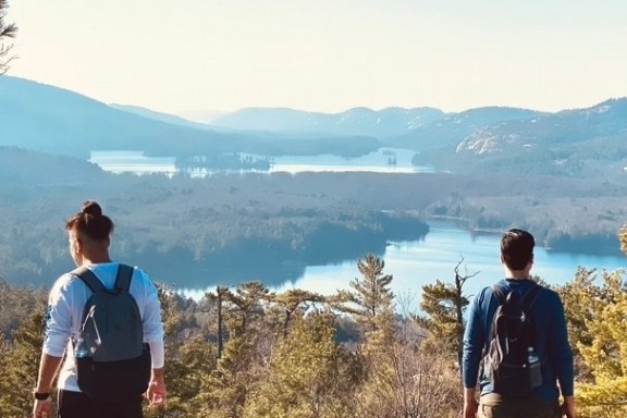 a group of people standing in front of a mountain