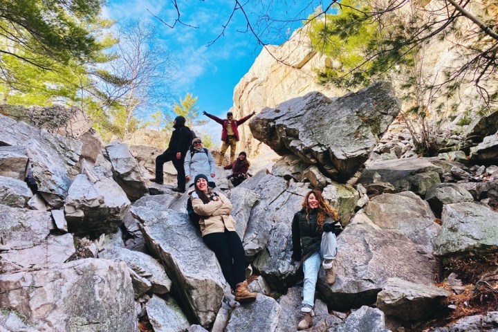 a couple of people that are standing in a rocky area