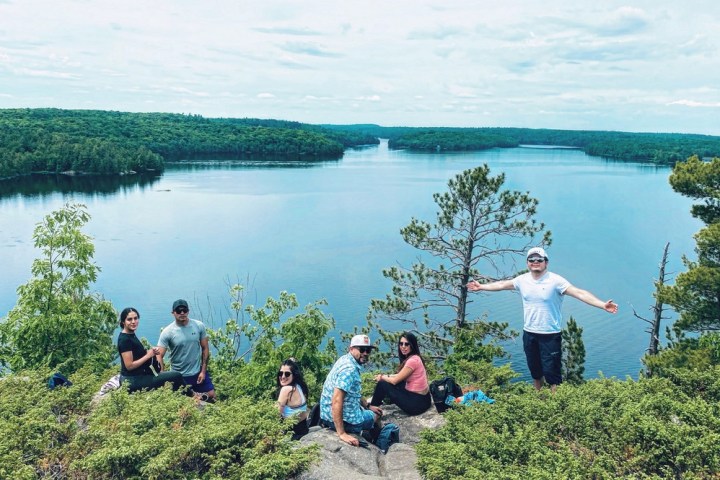 a group of people standing in front of a body of water